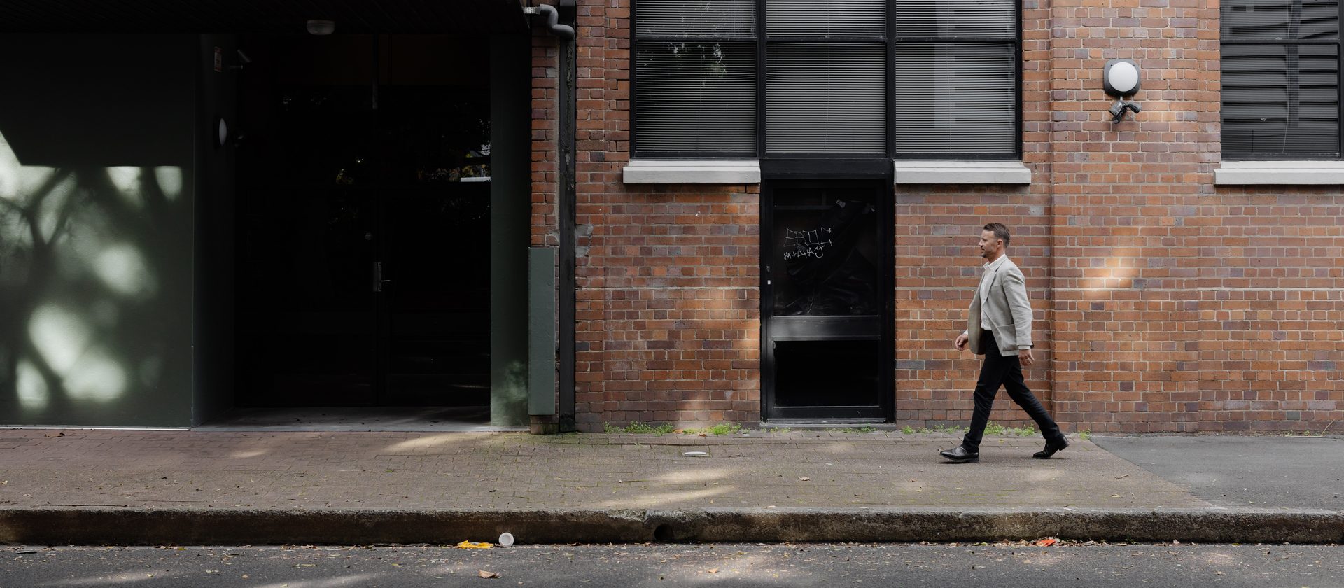 Tom Haigh walking past a commercial property