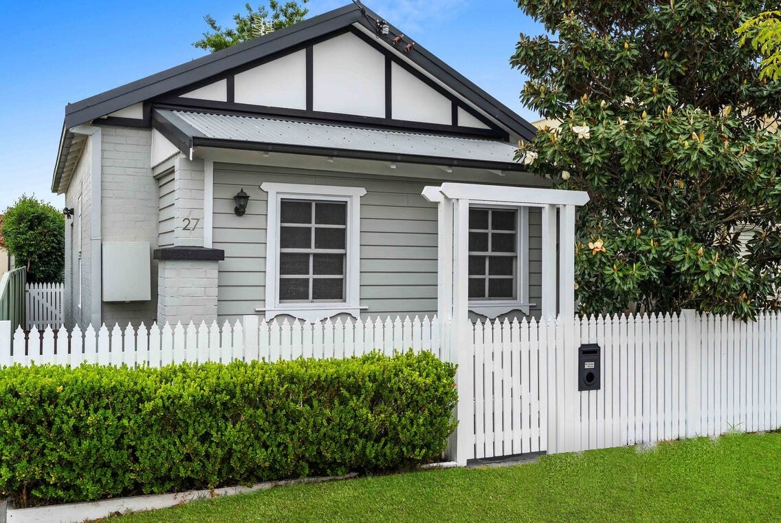 Weatherboard cottage with a white picket fence in Newcastle